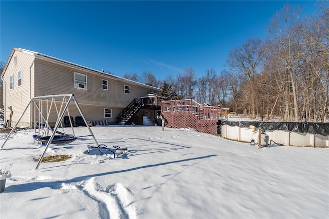 yard covered in snow with a deck