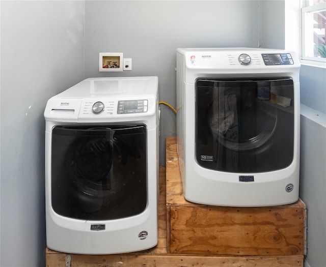 clothes washing area with washer and clothes dryer