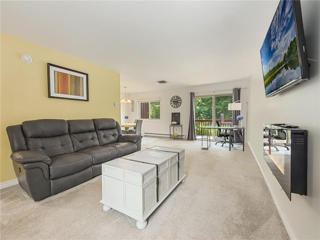 living room featuring light colored carpet, a chandelier, and a baseboard heating unit