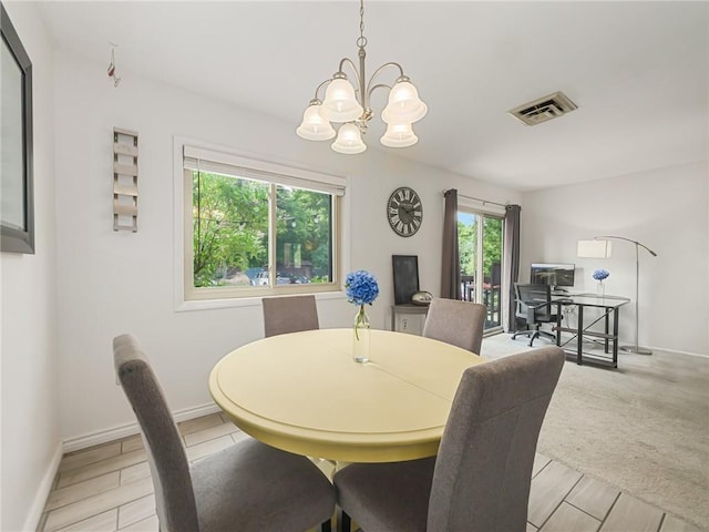 dining space with an inviting chandelier