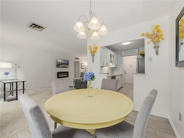 dining area featuring sink and a chandelier