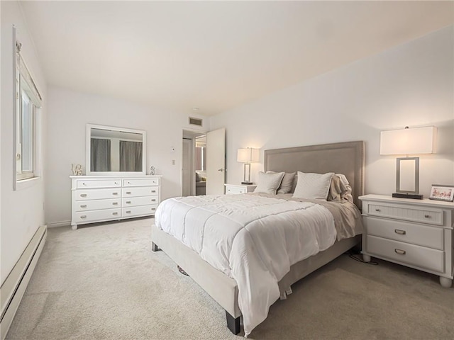 bedroom featuring a baseboard heating unit and carpet flooring