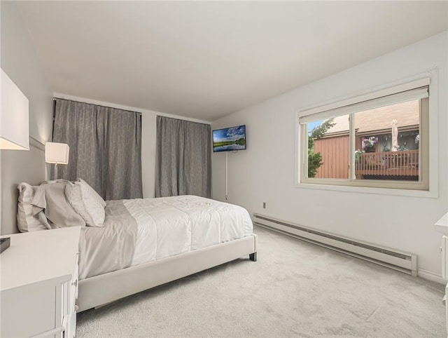 bedroom with a baseboard radiator and light colored carpet