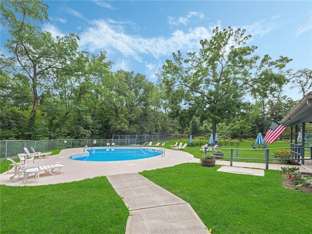 view of swimming pool with a yard and a patio