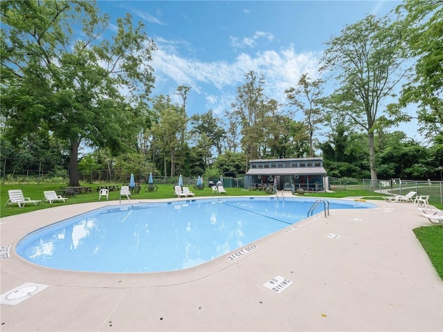 view of pool with a yard and a patio area