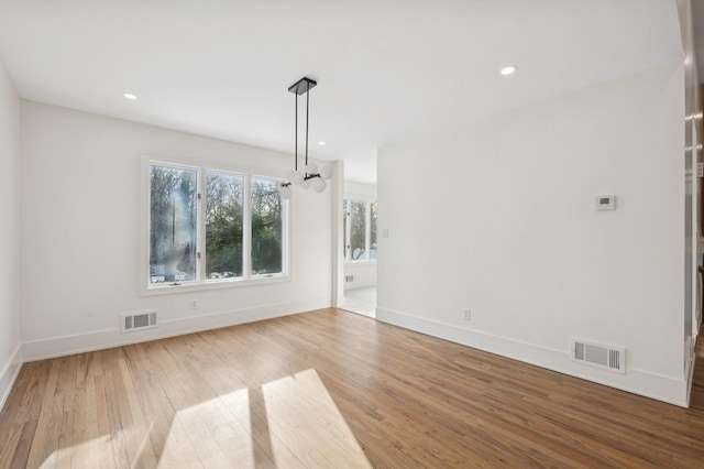 unfurnished dining area with wood-type flooring