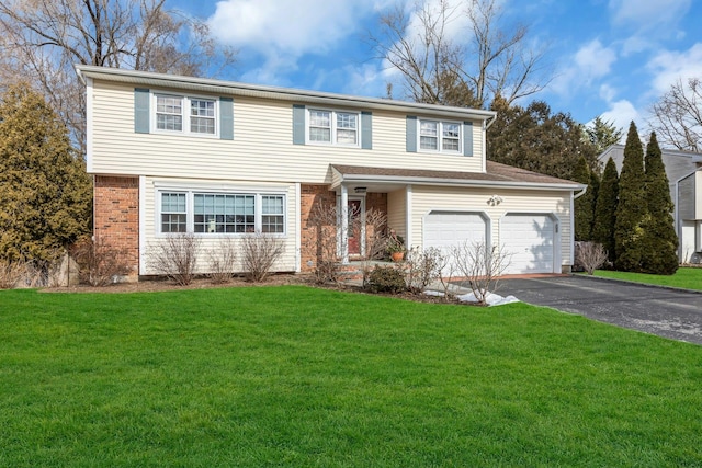 view of front property featuring a garage and a front yard