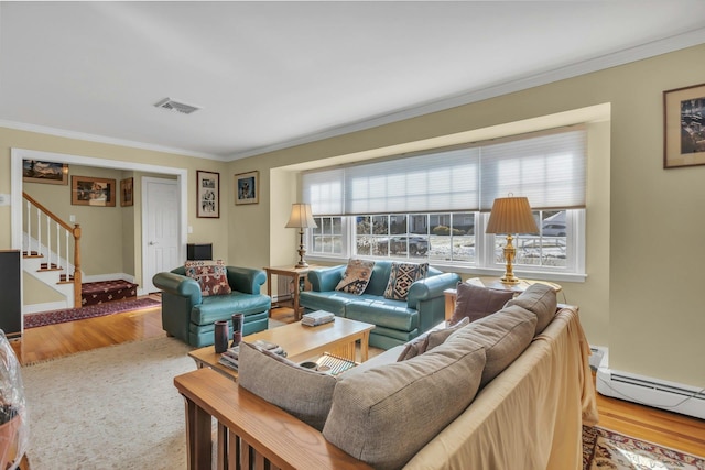 living room with hardwood / wood-style flooring, a baseboard radiator, and ornamental molding