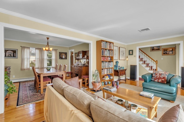 living room featuring light hardwood / wood-style flooring, ornamental molding, a chandelier, and baseboard heating