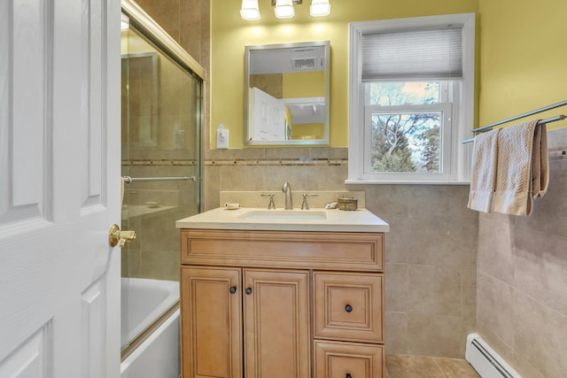 bathroom featuring a baseboard radiator, tile walls, and vanity