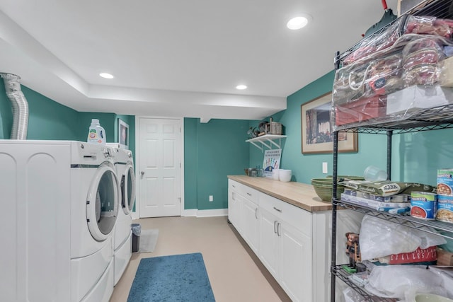 washroom featuring cabinets and independent washer and dryer