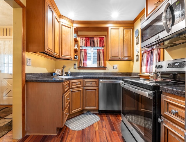 kitchen featuring dark wood-type flooring, appliances with stainless steel finishes, and sink