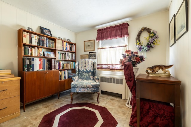 sitting room featuring radiator and light tile patterned flooring