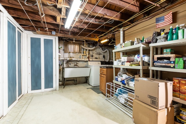 basement featuring washer / clothes dryer and sink