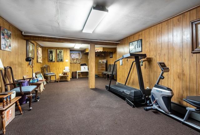 exercise area with carpet and wood walls