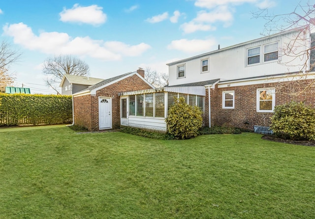 rear view of house with a yard