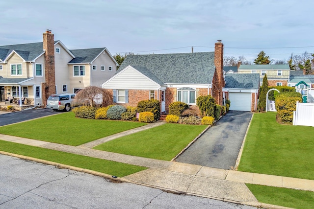 view of front of property featuring a garage and a front lawn