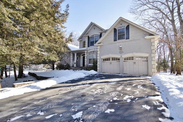 view of front of house with a garage and aphalt driveway