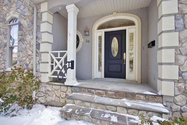 doorway to property featuring stone siding