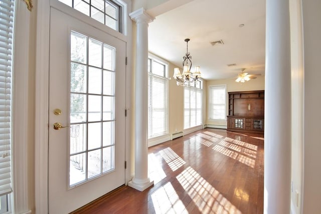 entryway featuring a baseboard radiator, decorative columns, visible vents, and wood finished floors