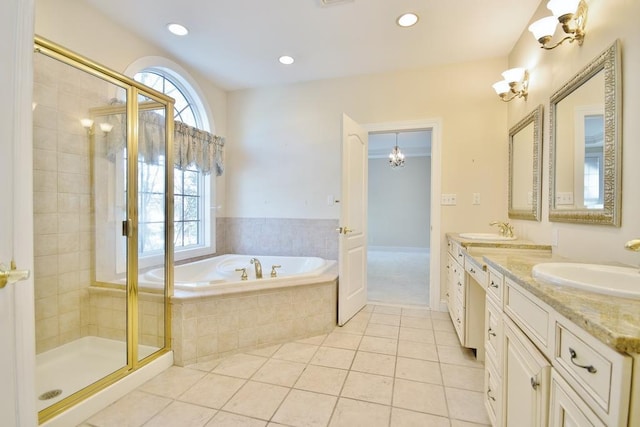 bathroom featuring a stall shower, tile patterned floors, a garden tub, a sink, and recessed lighting