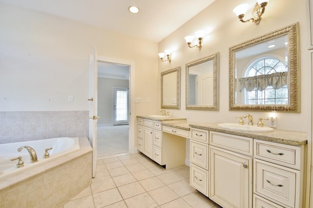 full bath with tile patterned floors, a sink, a bath, and double vanity