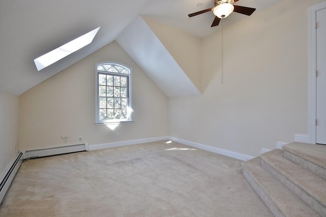 bonus room with lofted ceiling with skylight, baseboards, baseboard heating, and light colored carpet