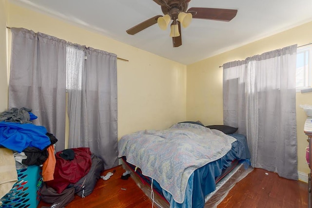 bedroom featuring dark wood-type flooring and ceiling fan