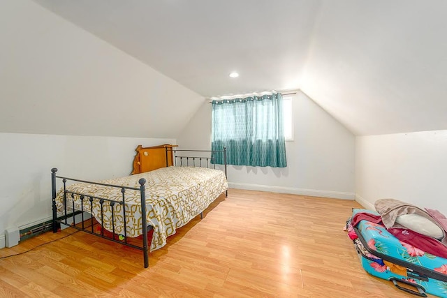 bedroom with hardwood / wood-style flooring and vaulted ceiling