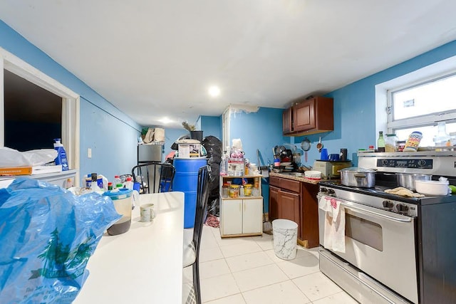 kitchen featuring light tile patterned floors and electric stove