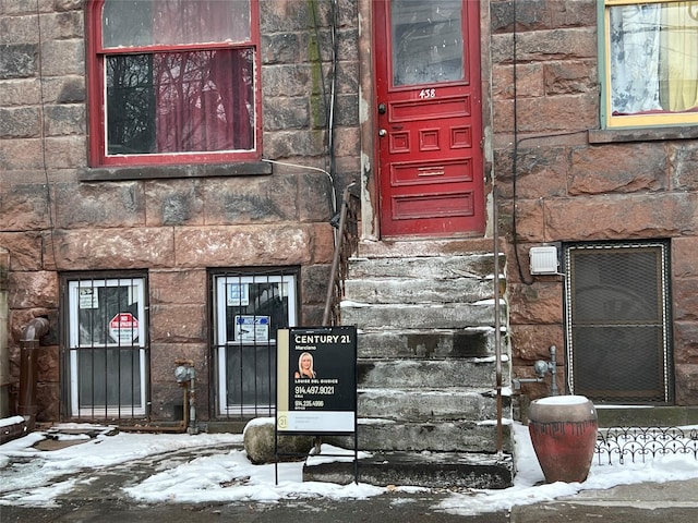 view of snow covered property entrance