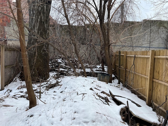 yard layered in snow with fence