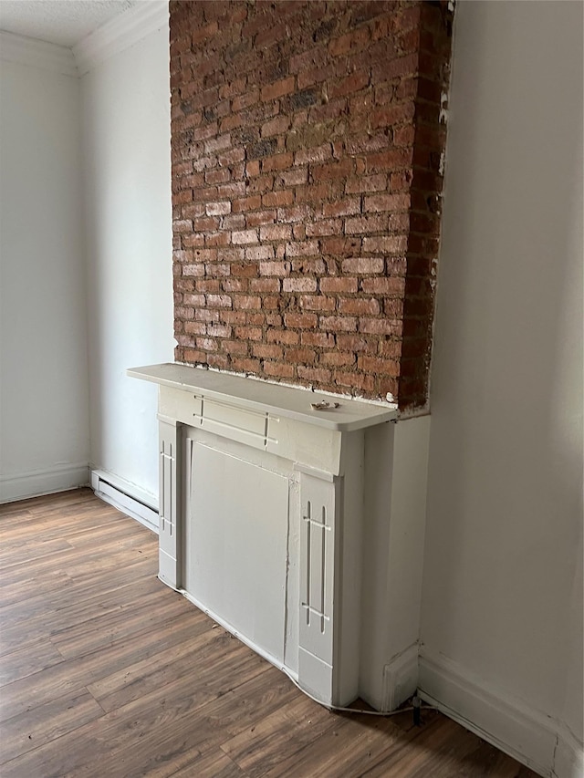 details featuring ornamental molding, baseboards, and wood finished floors