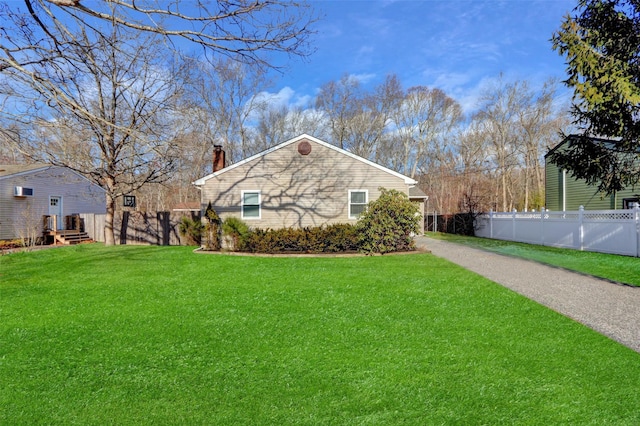 view of side of home with a yard