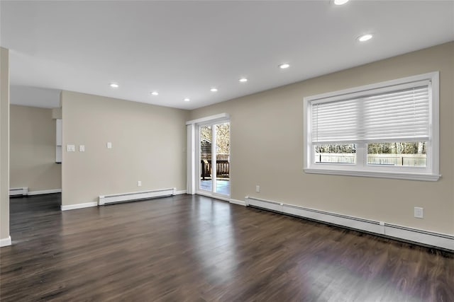 empty room featuring a baseboard radiator, dark hardwood / wood-style floors, and a wealth of natural light