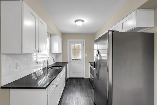 kitchen with sink, white cabinetry, stainless steel appliances, tasteful backsplash, and dark hardwood / wood-style flooring