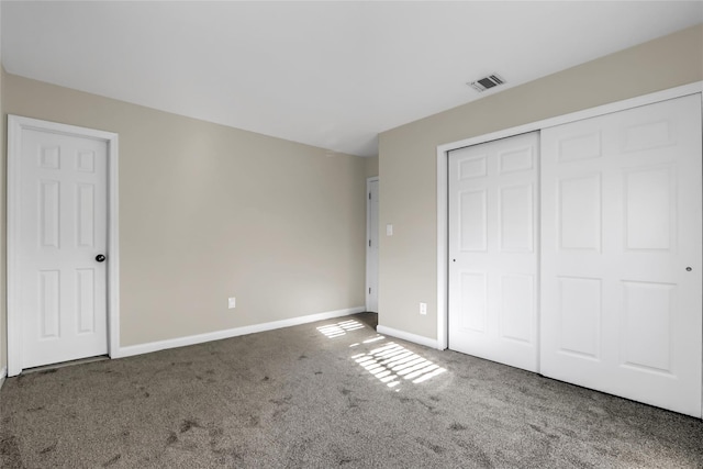 unfurnished bedroom with carpet floors and a closet