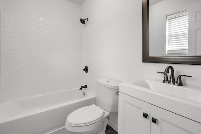 full bathroom featuring tiled shower / bath, vanity, and toilet