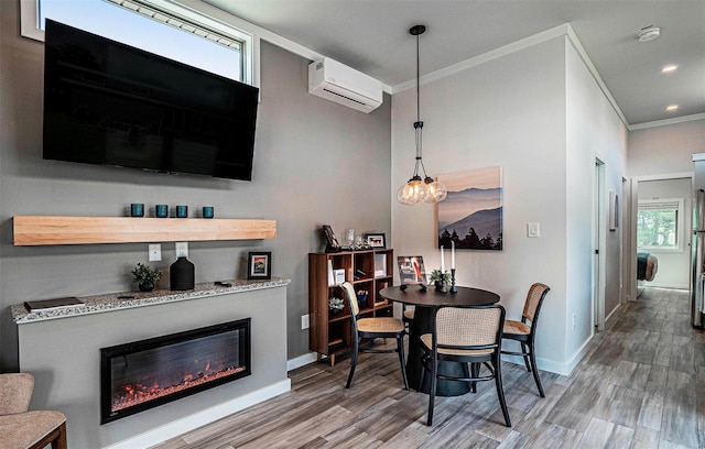 197 Wheeler Rd, Florida, NY 10921 - dining room with an AC wall unit, crown molding, wood finished floors, recessed lighting, and a glass covered fireplace