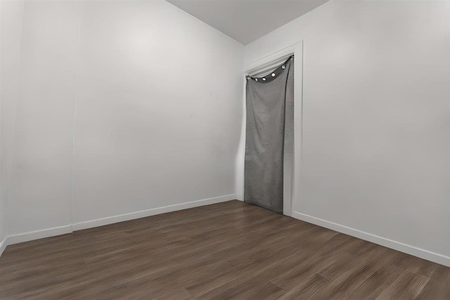 unfurnished room with dark hardwood / wood-style floors