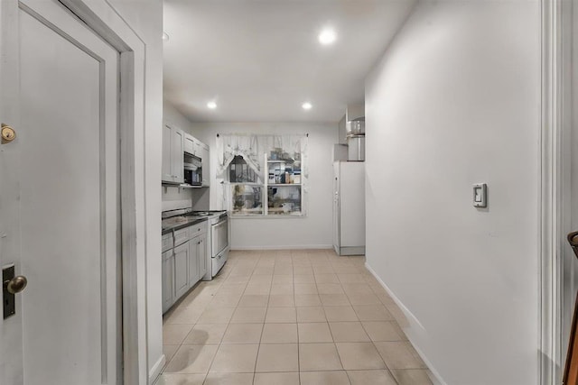 kitchen with white appliances and light tile patterned floors