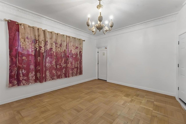 spare room with a chandelier, crown molding, and light parquet flooring