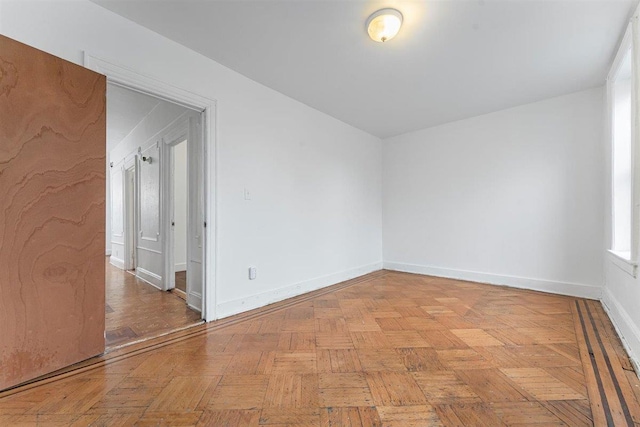 unfurnished room with light parquet flooring