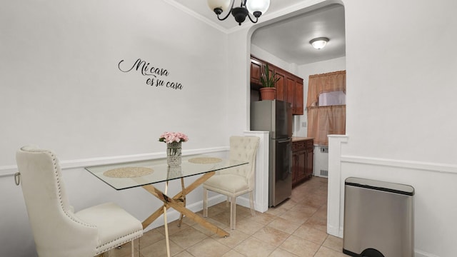 dining room featuring light tile patterned floors and a notable chandelier