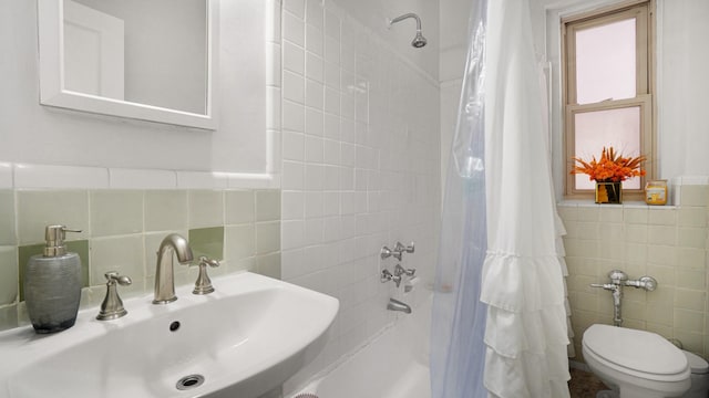 bathroom featuring tile walls, sink, and toilet