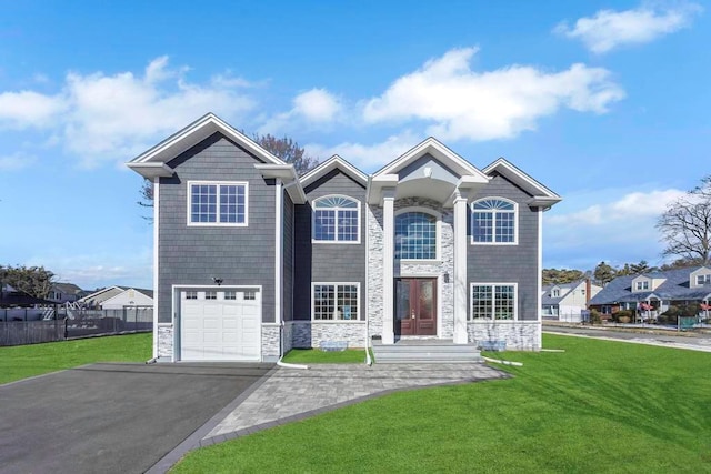 view of front of home featuring a garage and a front lawn