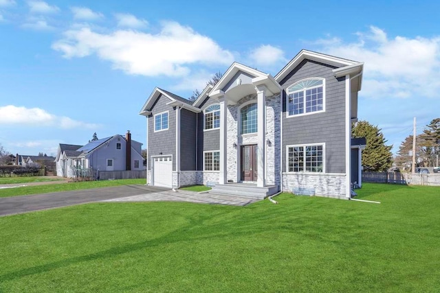 view of front of house featuring a garage and a front yard