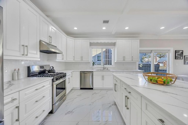 kitchen featuring appliances with stainless steel finishes, light stone countertops, and white cabinets