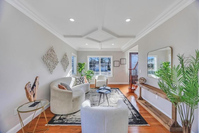 living room featuring ornamental molding, coffered ceiling, and hardwood / wood-style floors