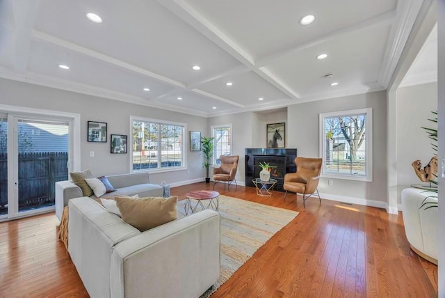 living room with crown molding, coffered ceiling, beam ceiling, and light hardwood / wood-style floors